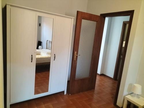 a room with a door and a mirror and a bedroom at Casa Rina in Nesso