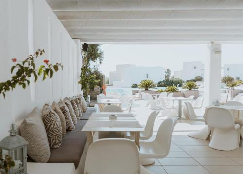 a row of chairs and tables in a restaurant at Archipelagos Resort in Agia Irini Paros