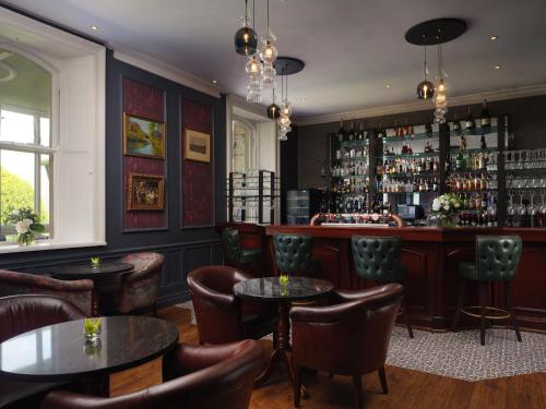 a bar at a restaurant with tables and chairs at Lyrath Estate in Kilkenny