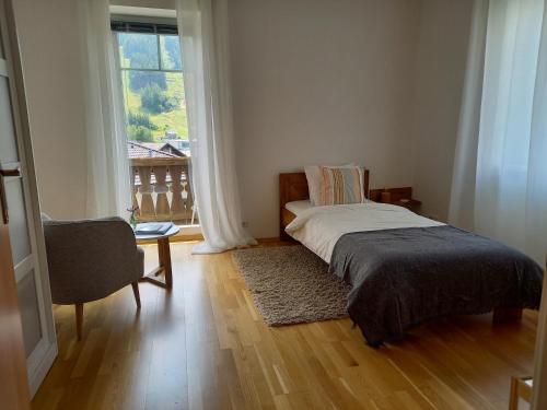 a bedroom with a bed and a large window at Landhaus Semmering in Semmering
