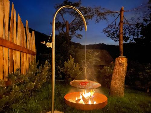 a bird bath with a fire in a yard at SkiBajkowa Chata in Szczyrk