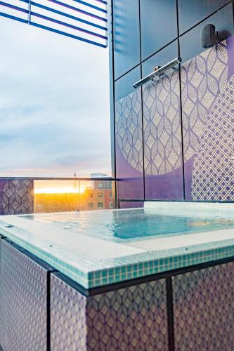 a swimming pool in a building with at Genting Hotel & Spa at Resorts World Birmingham in Bickenhill