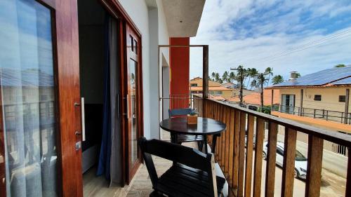 a balcony with a table and a view of a street at Pousada Sete Mares in Maragogi