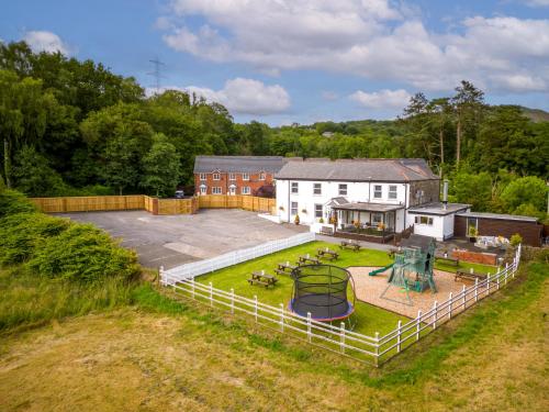 uma vista aérea de uma casa com um parque infantil em Entire Pub Sleeps up to 26 People Swansea - Your Own Pub Experience em Swansea