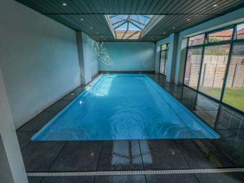 a large indoor swimming pool with a glass ceiling at Nightingales in Bridlington