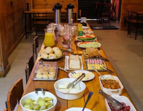 a long table with plates of food on it at Pousada Sete Mares in Maragogi