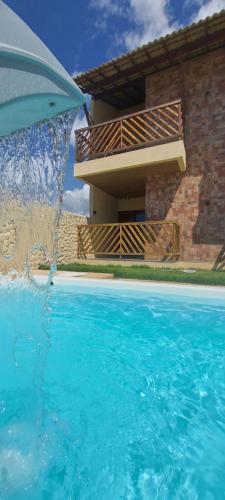 a water fountain in front of a house at Eloa Flats in Luis Correia