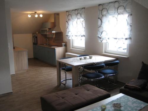 a kitchen and living room with a table and chairs at Haus Beate Groß in Kröv