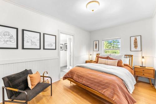 a bedroom with a bed and a chair at The Cottage On Wilsonville Road in Wilsonville