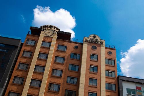 a tall building with a clock on top of it at Hotel Splendor by Friends Company in Bogotá