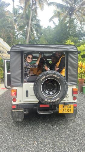 a group of people in the back of a jeep at Fab Valley Homestay in Munnar