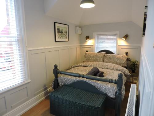 a bedroom with a bed with a bench in it at Bespoke Luxury Serviced Apartment in Macclesfield