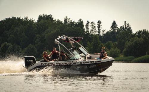 a group of people on a boat in the water at Kupiškėnų Starkėnas in Palėvenėlė