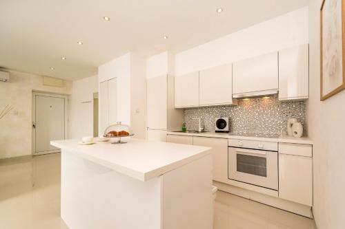 a kitchen with white cabinets and a white counter top at URBAN LUXURY APARTMENT in Zadar
