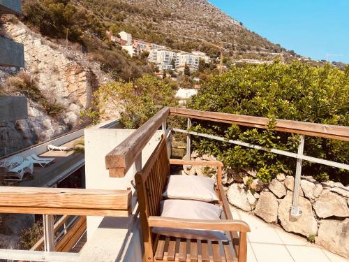 a balcony with a bench and a mountain at Sunny Home Costa Plana-Monaco -Cap D'Ail in Cap d'Ail