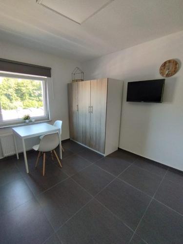 a room with a table and a table and a window at Aparthotel Siegen in Siegen