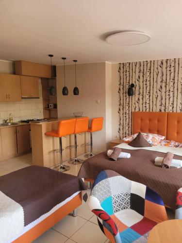 a bedroom with two beds and a kitchen at FALA na WYSPIE in Sobieszewo