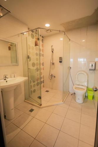 a bathroom with a shower and a toilet at See Hualien B&B in Hualien City