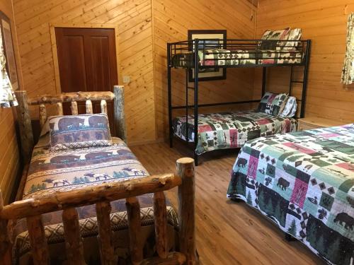 a room with two beds and a bunk bed at Grandview Cabins & RV Resort in South Fork