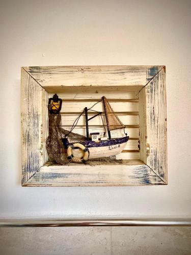 a picture of a painting of a boat in a frame at Il Rio Grande in Beverino