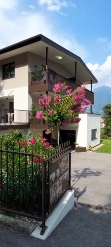 a house with pink flowers on a fence at Marlingsuites - Vinea - Wieser Josef - Marling in Marlengo