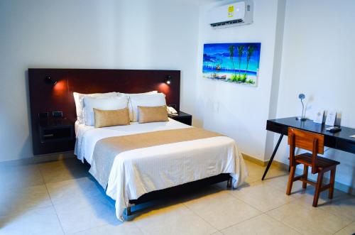 a hotel room with a bed and a television at Hotel Playa Club in Cartagena de Indias