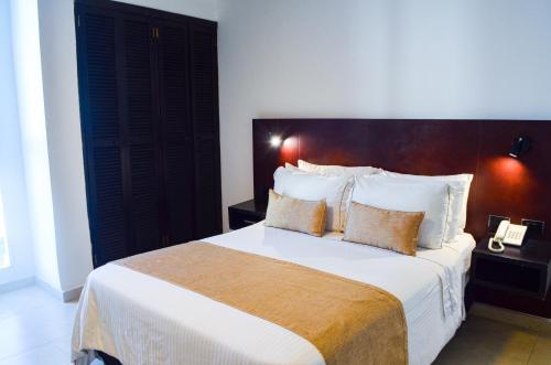 A bed or beds in a room at Hotel Playa Club