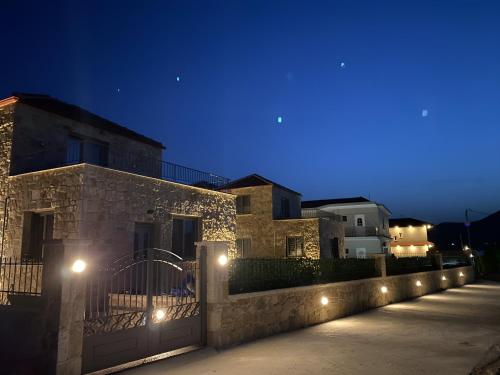 a fence with lights on the side of a building at VILLAS BALATSOURAS in Paleros