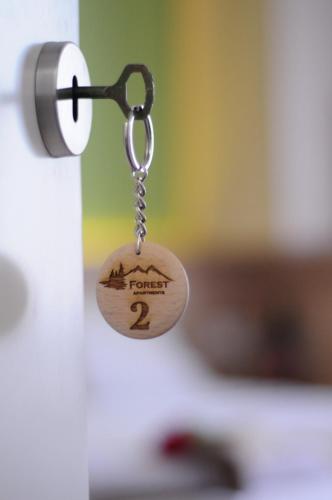 a key chain with the words frontier on it at Forest Apartments in Bitola