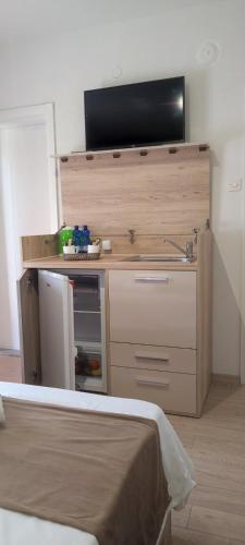 a room with a tv on top of a counter at Forest Apartments in Bitola