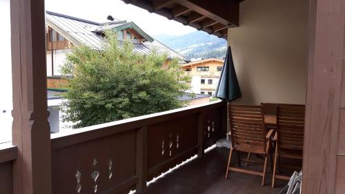 a balcony with a table and chairs and a view at Gästehaus Roland in Kirchberg in Tirol