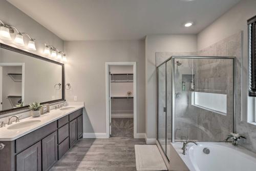 a bathroom with two sinks and a shower and a tub at Aledo Home with Covered Patio and Spacious Yard! in Willow Park