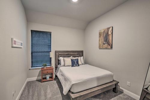 a bedroom with a large bed and a window at Aledo Home Covered Patio and Yard, Near Fort Worth! in Willow Park