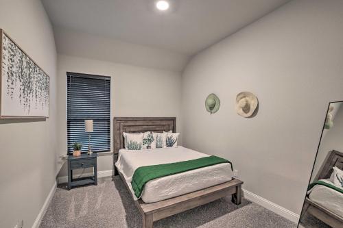 a small bedroom with a bed and a window at Aledo Home Covered Patio and Yard, Near Fort Worth! in Willow Park