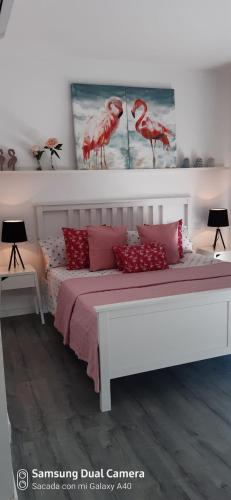 a bedroom with a large white bed with red pillows at Ca Na Xisca in Felanitx
