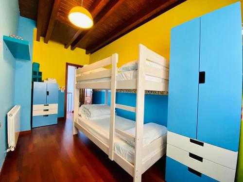 a bunk bed room with two bunk beds and a yellow wall at Casa Forn in Pujal