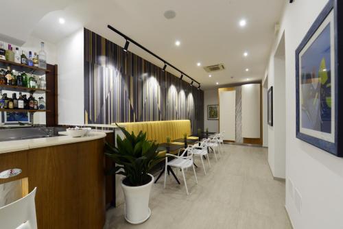 a restaurant with a bar and tables and chairs at Best Western Hotel Martello in Lampedusa
