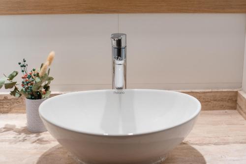 a white bath tub with a faucet in a bathroom at Gran Hotel Dakar in Mendoza