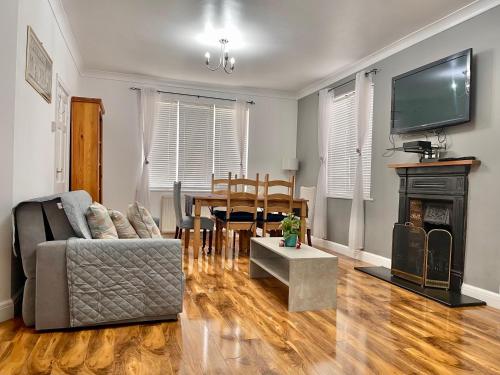 a living room with a couch and a table at Penny Lein Apartments in Uxbridge
