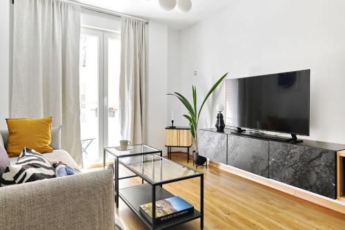a living room with a large flat screen tv at Wehaus - Exclusive & nordic style apartment in Murcia in Murcia