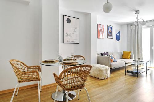 a living room with a table and chairs and a couch at Wehaus - Exclusive & nordic style apartment in Murcia in Murcia