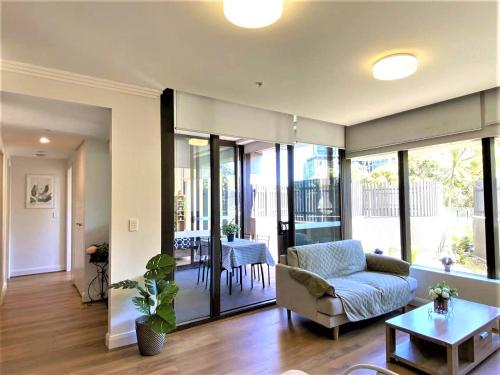 a living room with a couch and a table at Greenview in Sydney Olympic Park in Sydney