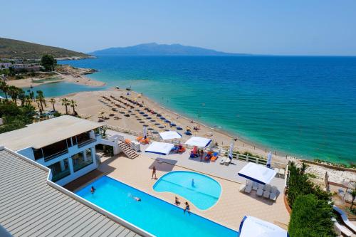 an overhead view of a beach with a swimming pool at Hotel Emblem in Sarandë