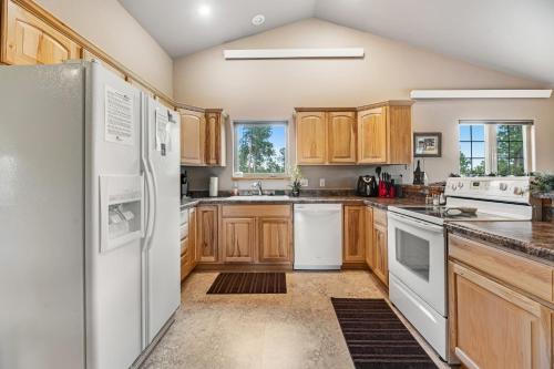 a kitchen with wooden cabinets and white appliances at Cliffview Cabin in Nemo