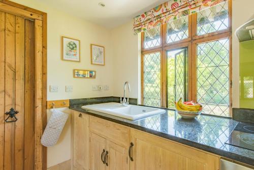 a kitchen with a sink and a window at The Gate House by Bloom Stays in Folkestone