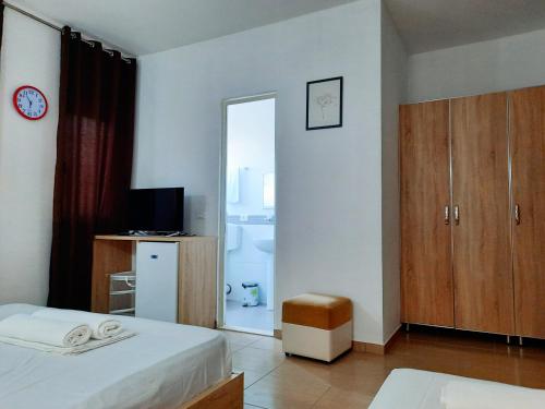 a bedroom with two beds and a mirror at Apartments Alavana in Velipojë