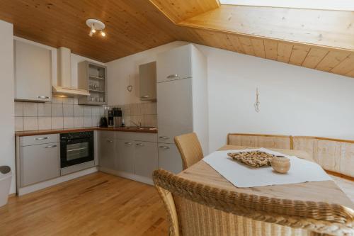 a kitchen with a table and chairs in a room at Ferienwohnung Hoche in Vandans