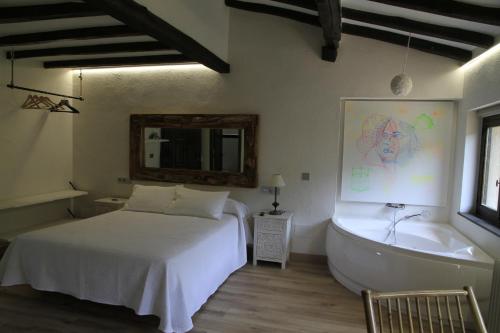a bedroom with a bed and a bath tub at La Posada de la Xana in Llanuces