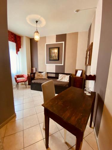 a living room with a table and a couch at Art Hotel Pandos in Tabiano