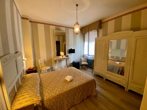 a bedroom with a large bed and a room with at Art Hotel Pandos in Tabiano